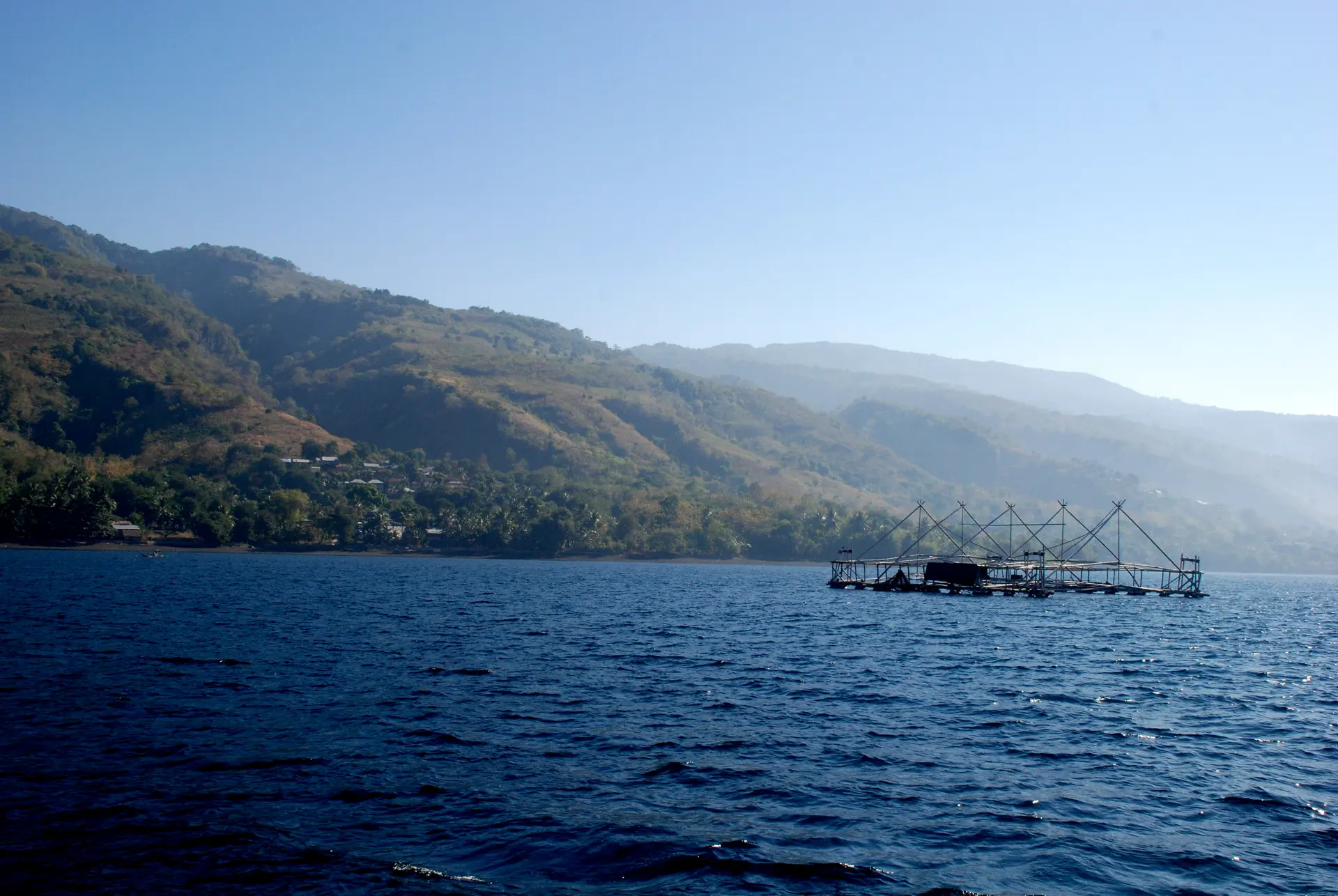 Calm water of Kalabahi Bay with hills of Alor in the background