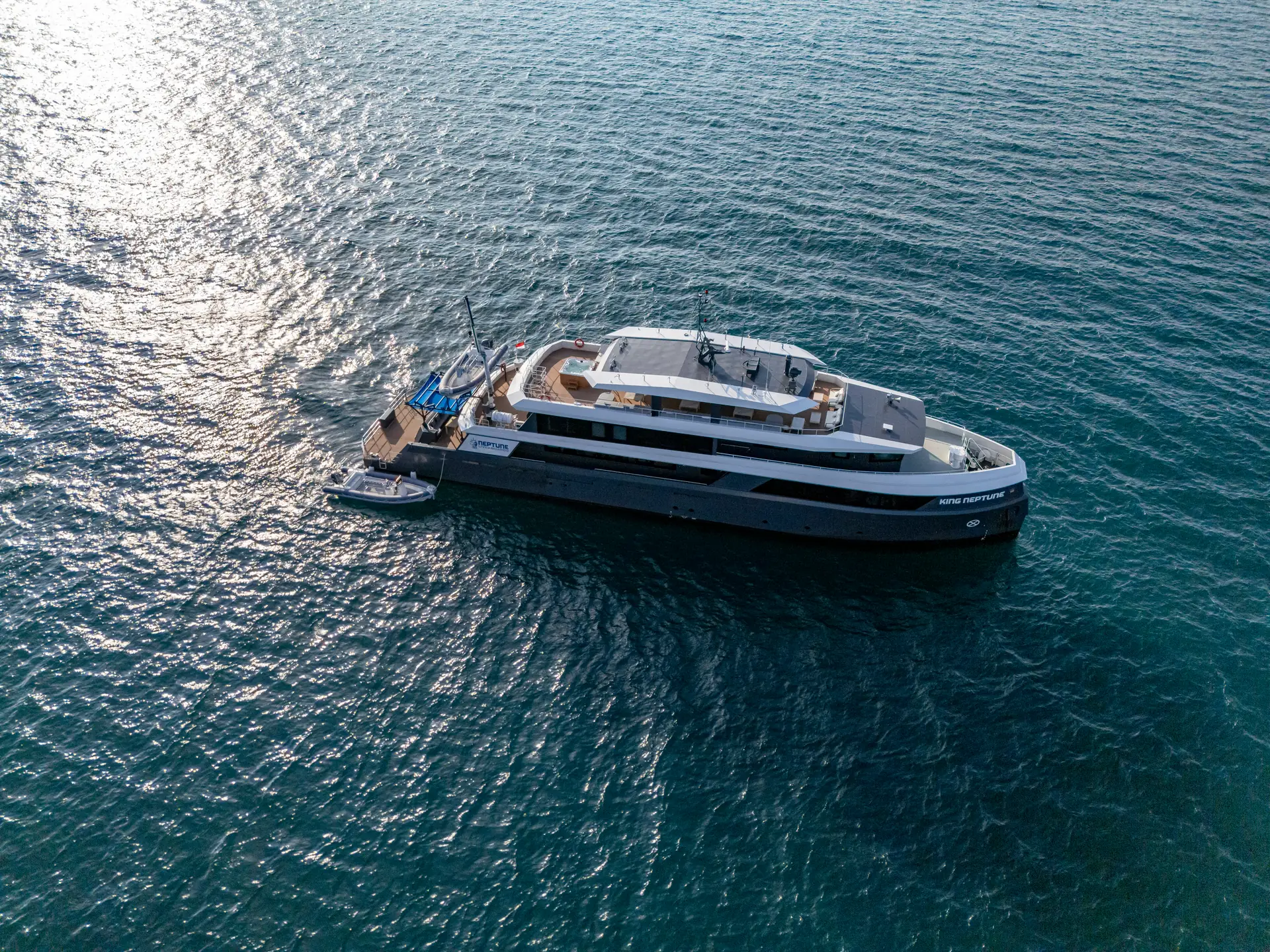 King Neptune liveaboard yacht at anchor in clear Indonesian water
