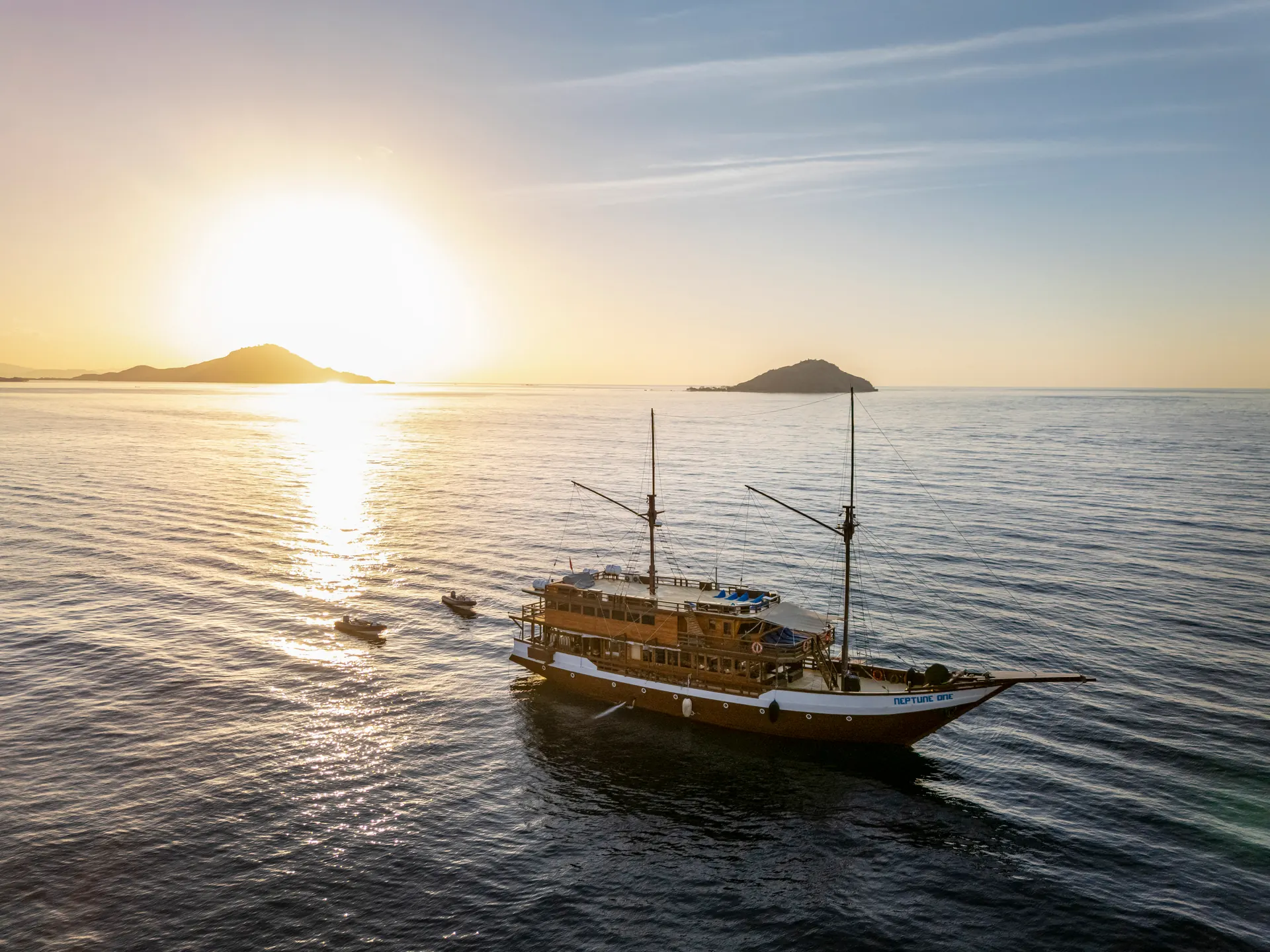 Neptune One phinisi liveaboard seen from above at sunset